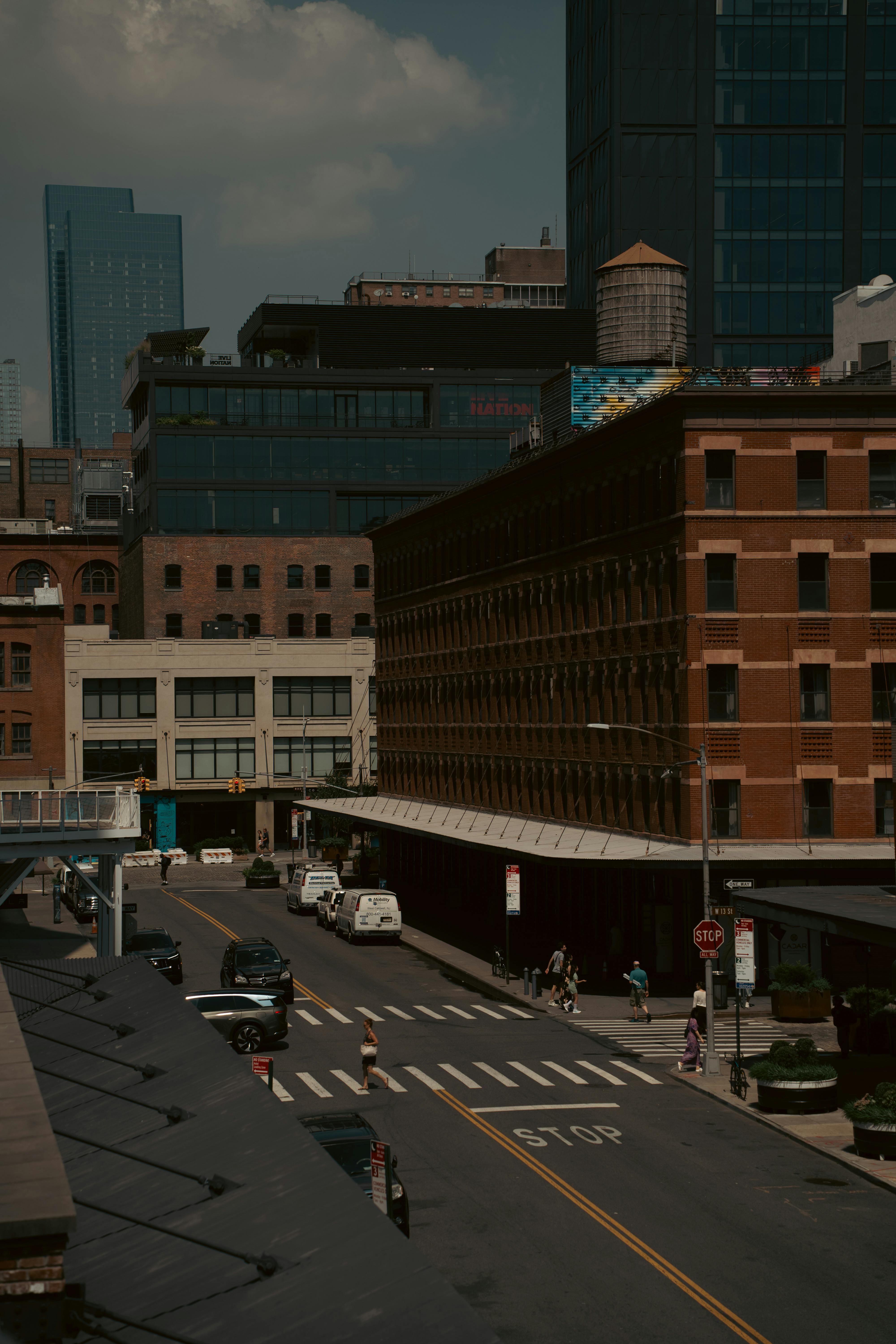 A bustling city street with historic brick buildings in an urban setting.