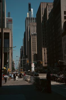 Vibrant New York City street bustling with people and towering skyscrapers.
