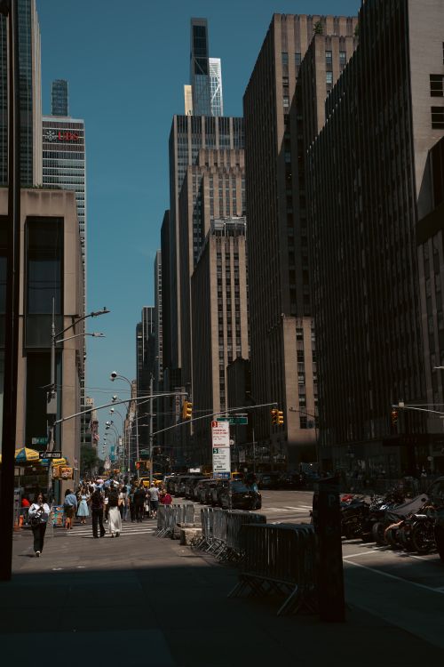 Free Vibrant New York City street bustling with people and towering skyscrapers. Stock Photo