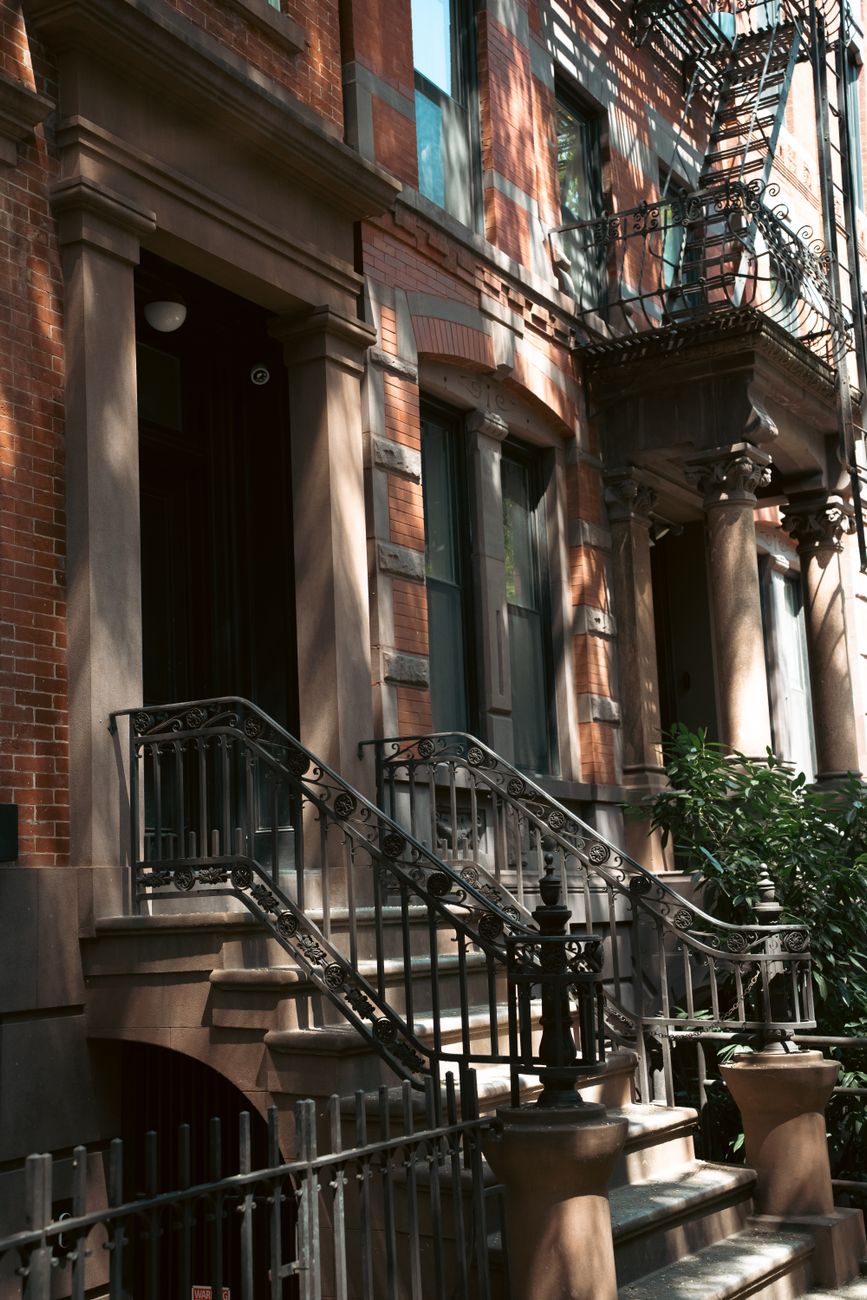 Brownstone stoop with iron railings on a Hoboken rowhouse