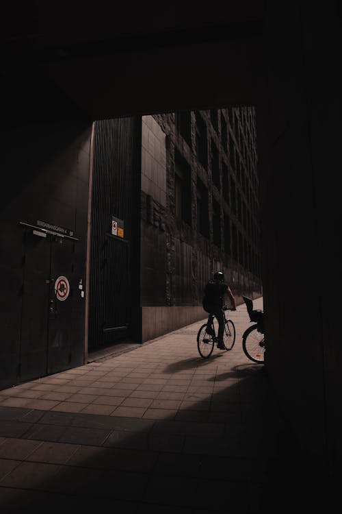 Man on Bike Near Building