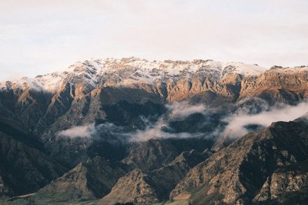 Snow-dusted mountain ridge under low cloud — photo by Shashank Brahmavar on Pexels
