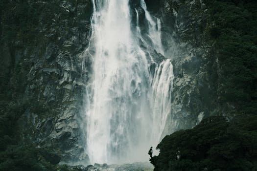 Discover the breathtaking waterfall cascading down the rugged cliffs at Milford Sound, New Zealand.