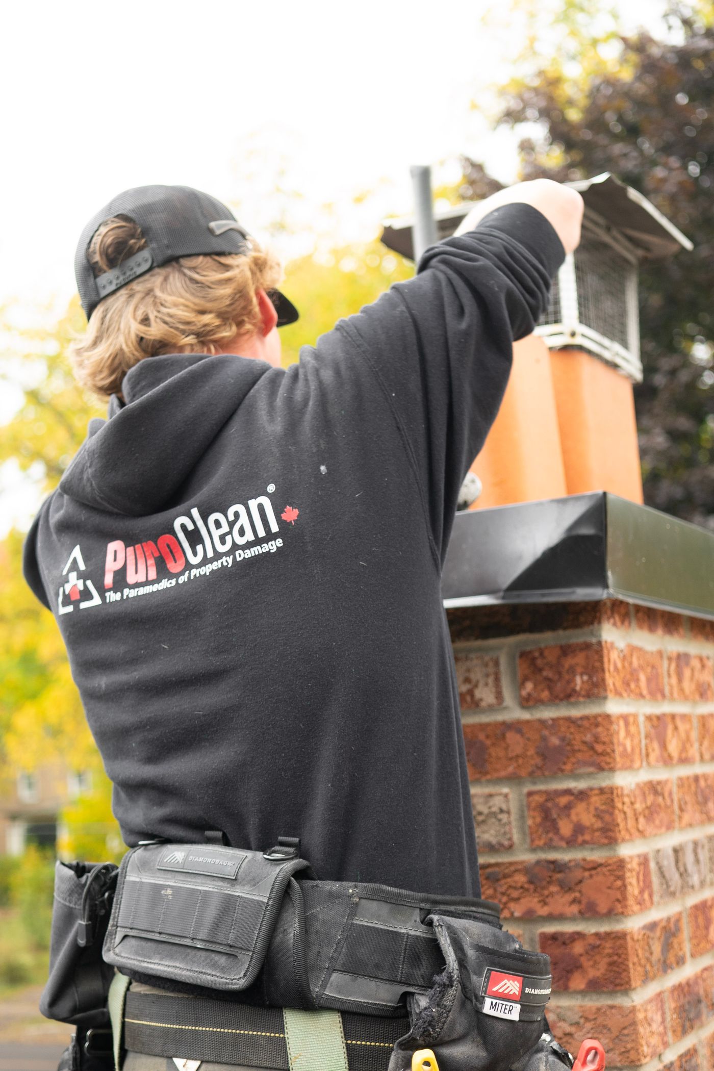Chimney professional cleaning a residential fireplace
