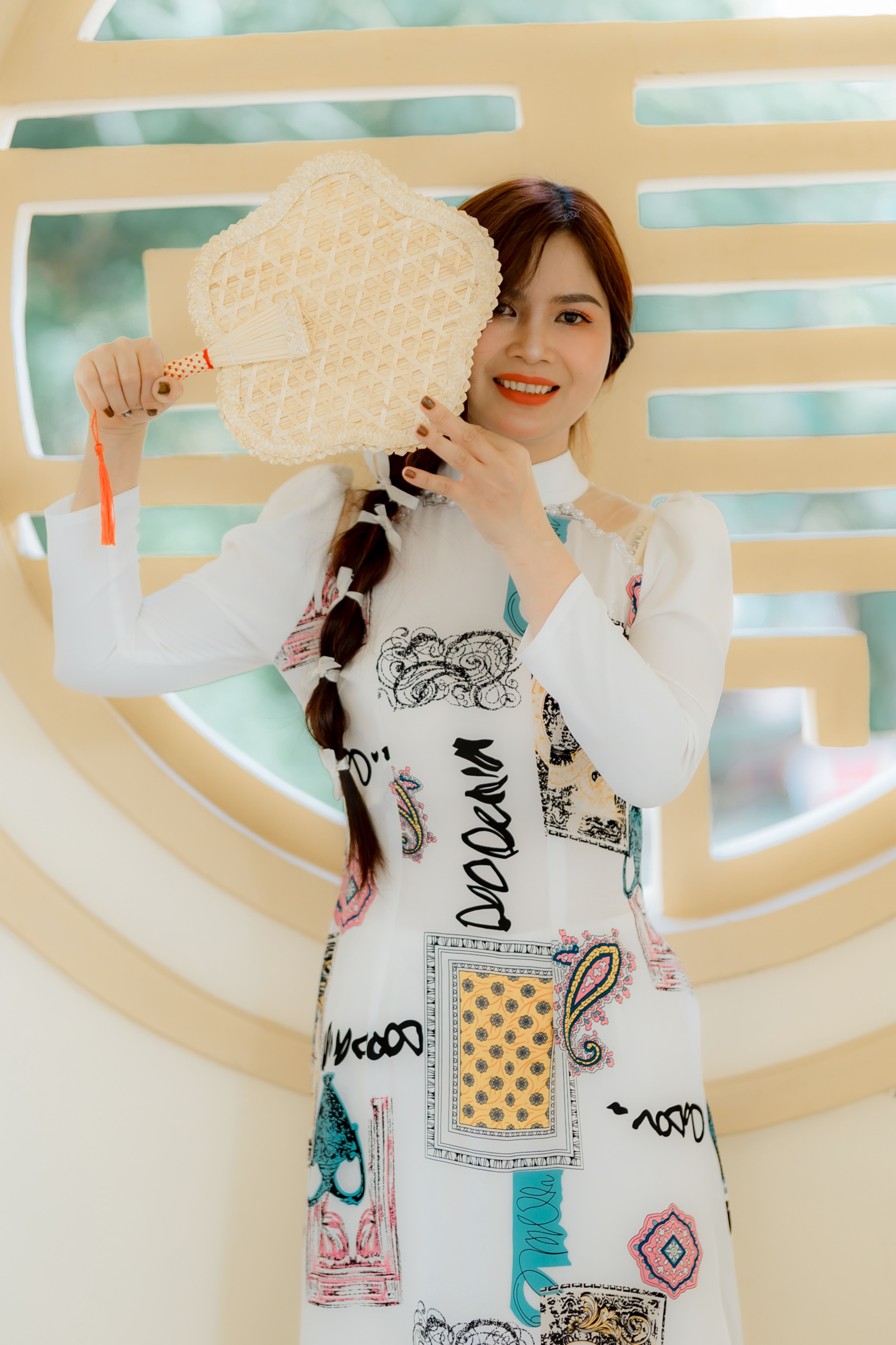 Smiling Woman in Modern Dress with Straw Fan · Free Stock Photo