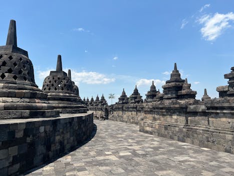Explore the ancient beauty of Borobudur Temple, a UNESCO site in Central Java, bathed in sunlight.