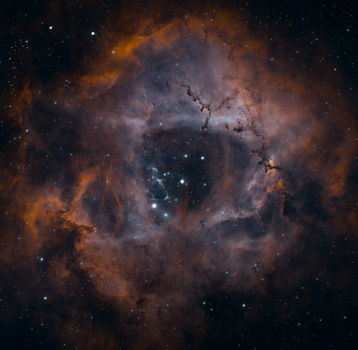 Explore the stunning Rosette Nebula, showcasing vibrant colors and distant stars in deep space.