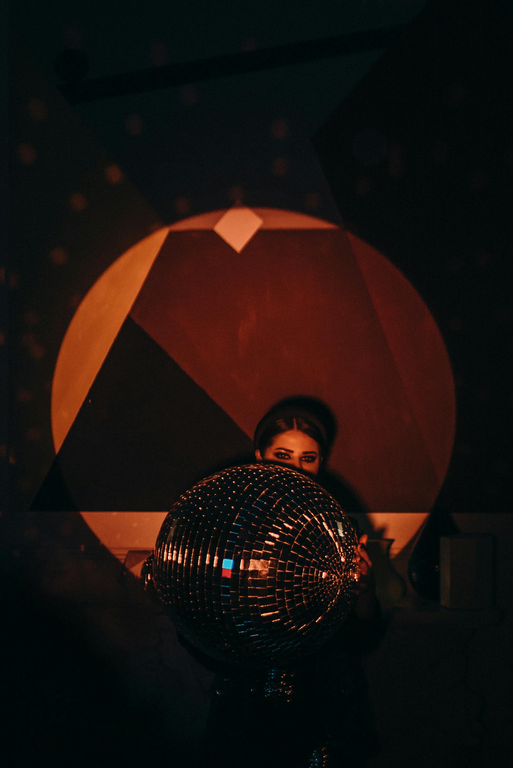 woman holding mirror ball