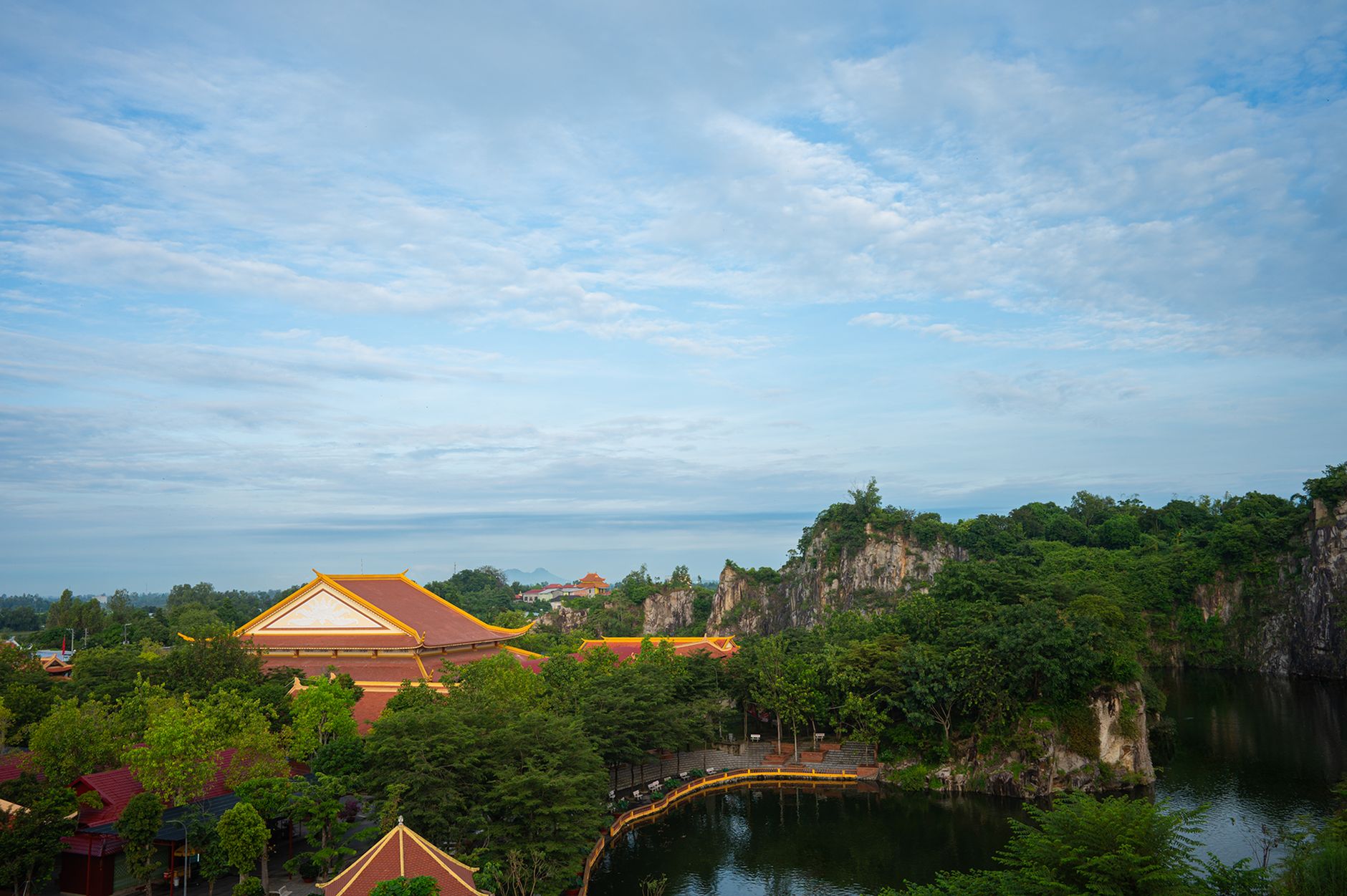 A serene view of a temple surrounded by lush greenery in An Giang, Vietnam.