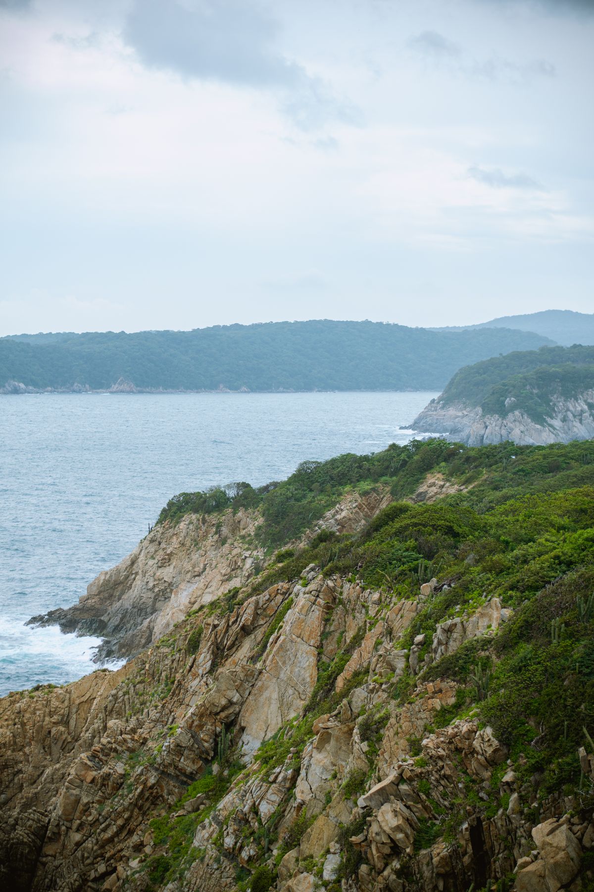 Breathtaking view of rocky coastline and ocean in Huatulco, Mexico, ideal for nature enthusiasts.