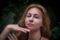 Woman Posing with Millipede in Nature Setting