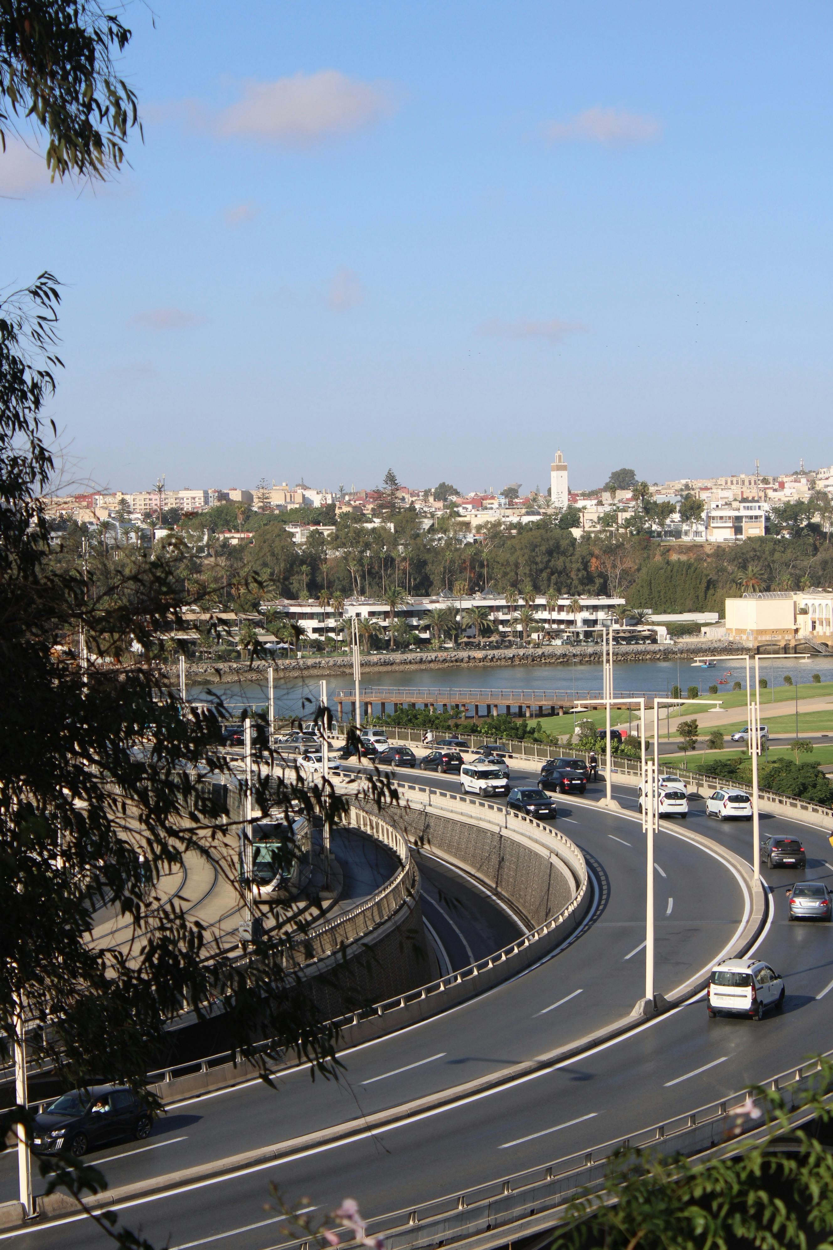 Cityscape of Rabat with a busy highway and river view, showcasing urban life in Morocco.