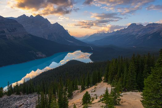 Capture of Peyto Lake at sunset with vibrant reflections and dramatic skies, nestled in the Canadian Rockies.