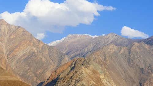 Free Scenic view of Gilgit-Baltistan mountains with clear blue sky and fluffy clouds. Stock Photo