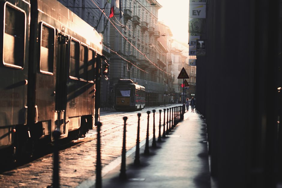 Street view of a tram in central Milan during sunset, capturing the urban ambiance.