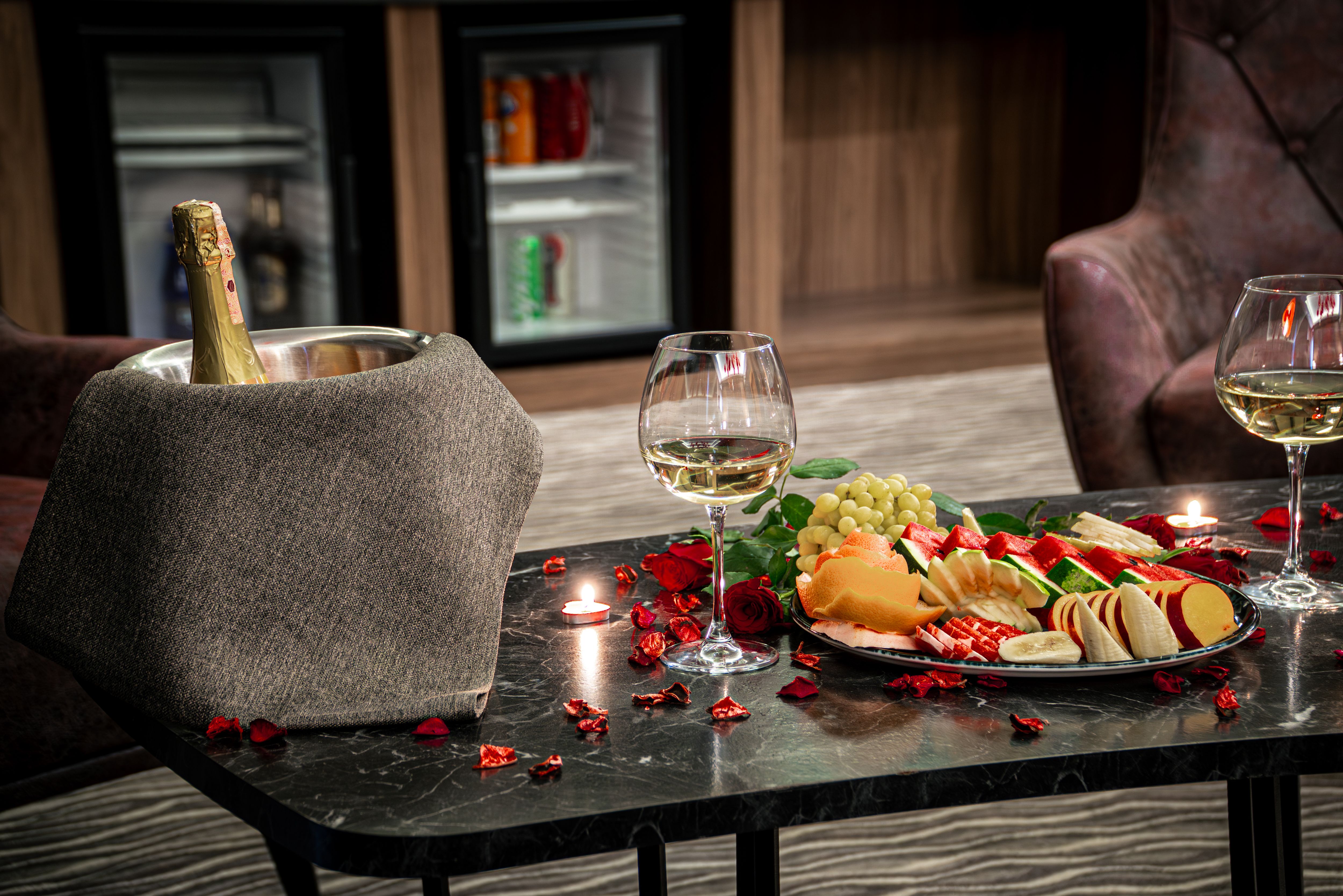 Luxurious Hotel Room Setting with Wine and Fruit Plate · Free Stock Photo