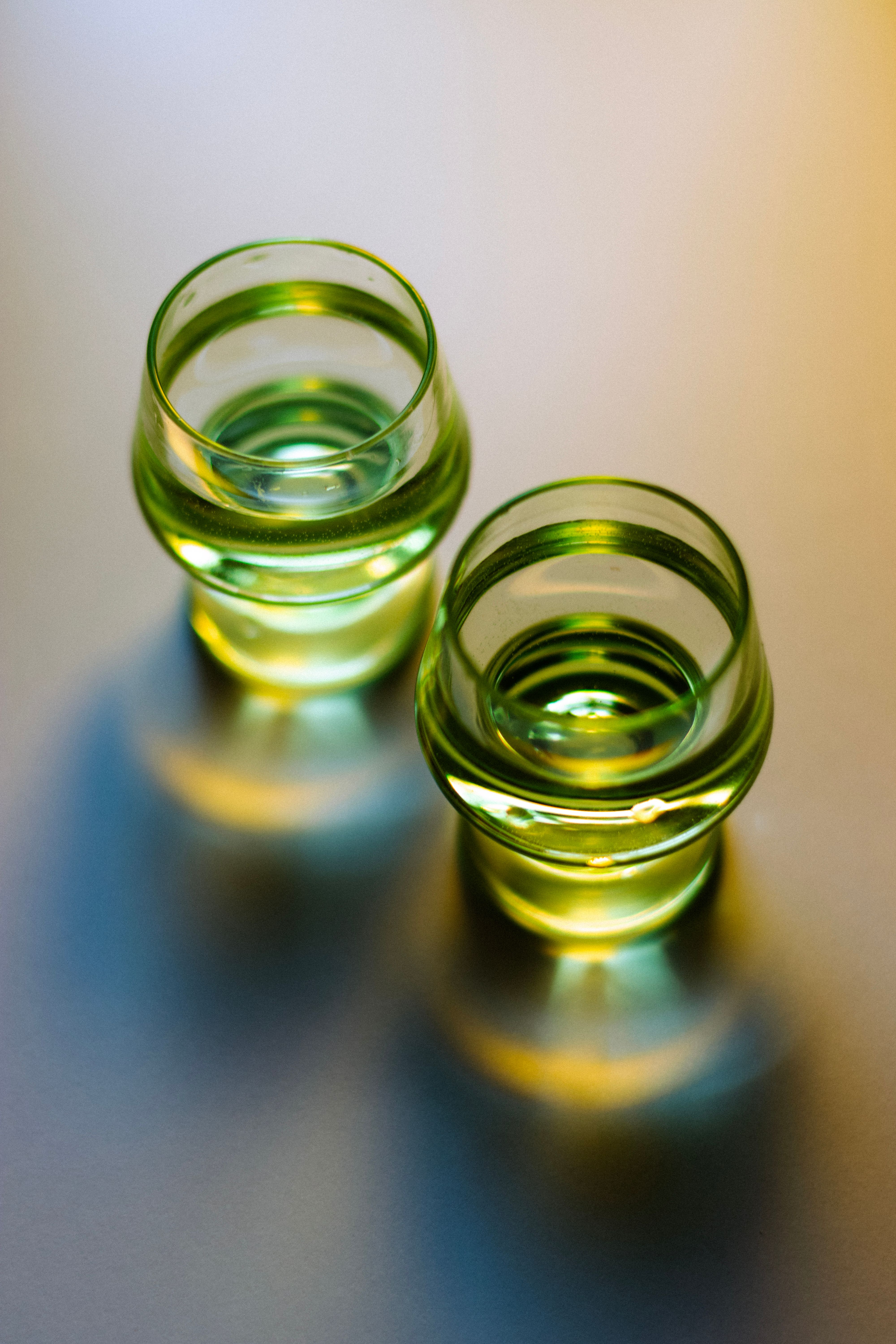 Elegant Glass Cups with Artistic Light Reflections · Free Stock Photo