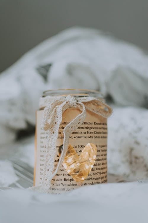 Macro Photography of Clear Glass Jar With Bow Accent