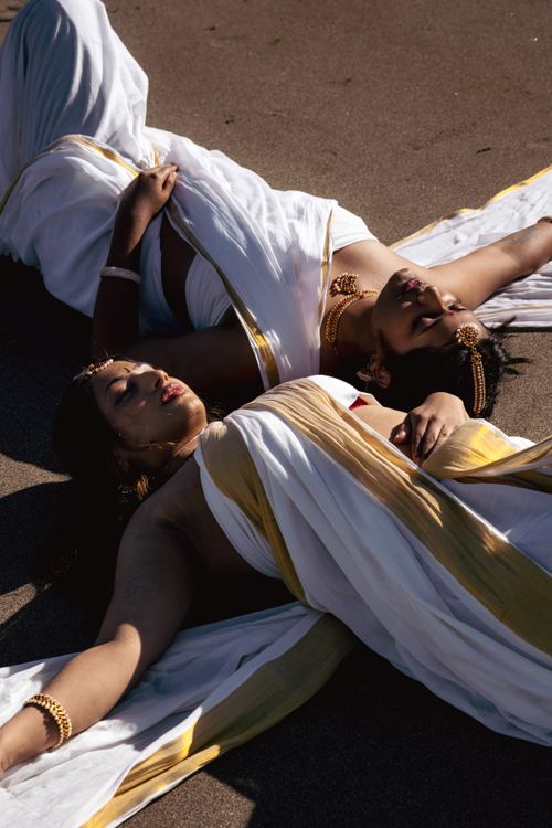 Free Elegant portrait of women in traditional sarees with golden accessories on a sunny Vancouver beach. Stock Photo