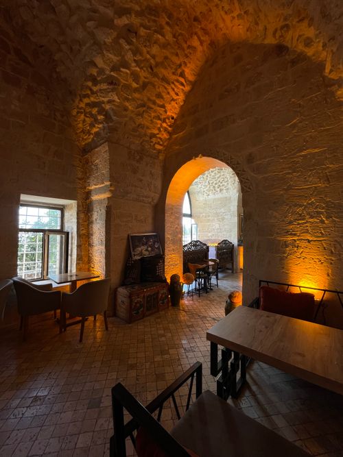 Free Charming stone room with arches and warm lighting, perfect for dining. Stock Photo