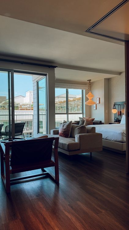 Hotel room with bed, seating and balcony doorway