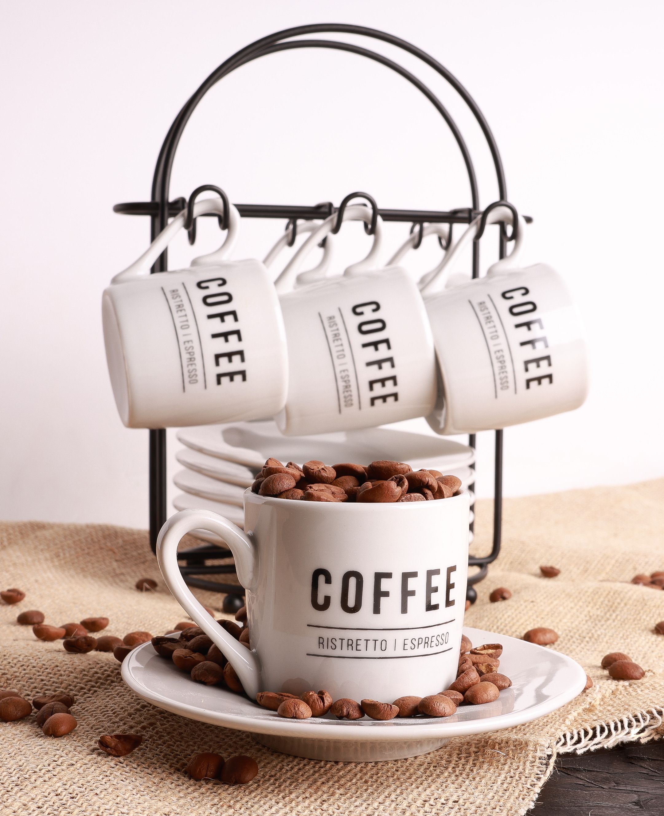 wall mounted wood mug rack above a small floating shelf coffee station in a corner