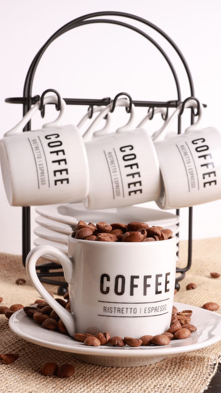 wall mounted wood mug rack above a small floating shelf coffee station in a corner