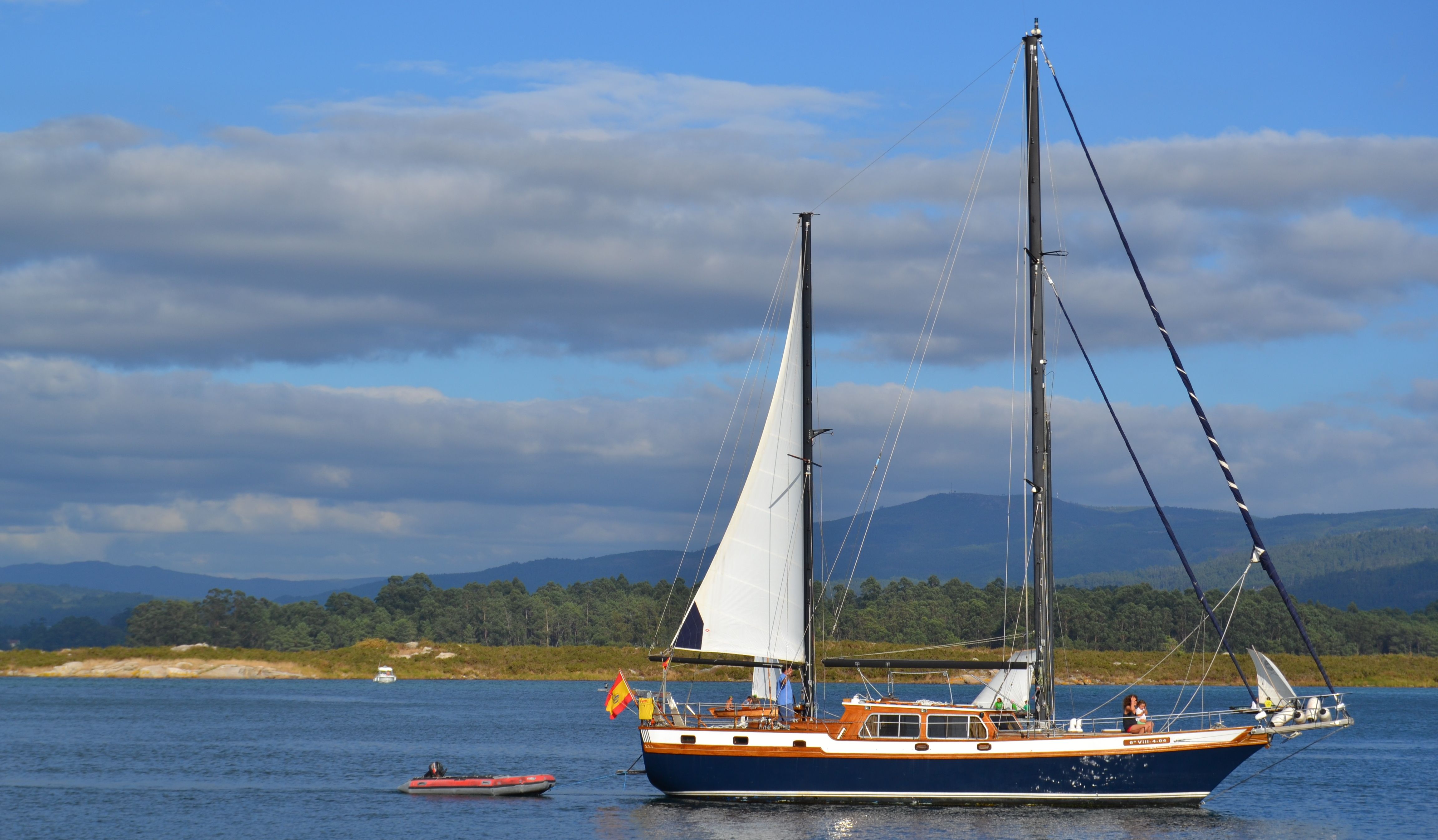 Sailboat Navigating Serene Waters with Mountains