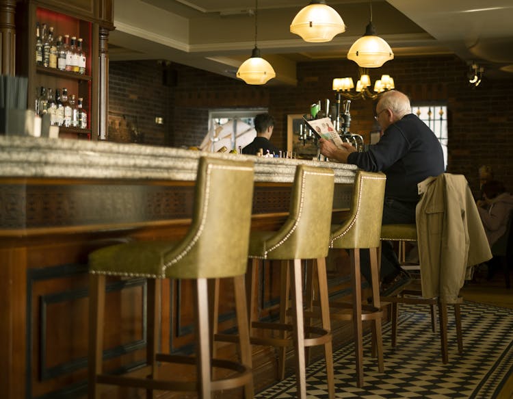 A Man Sitting At The Bar