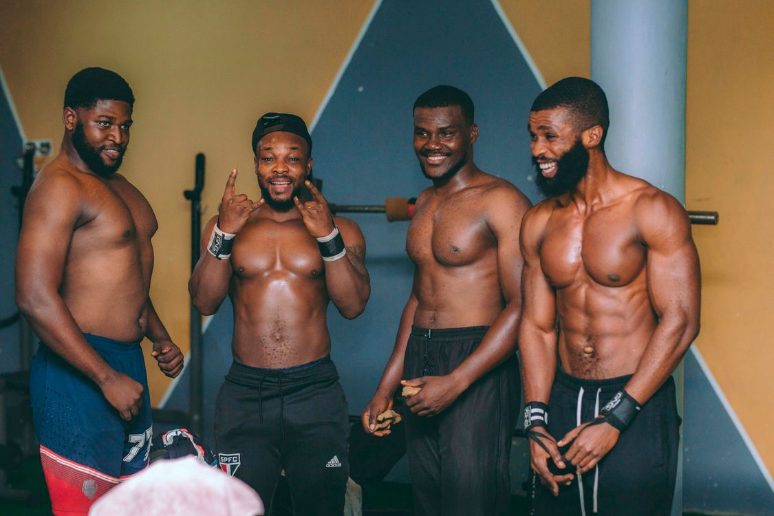 Group of Fit Men Posing Relaxed in Gym · Free Stock Photo