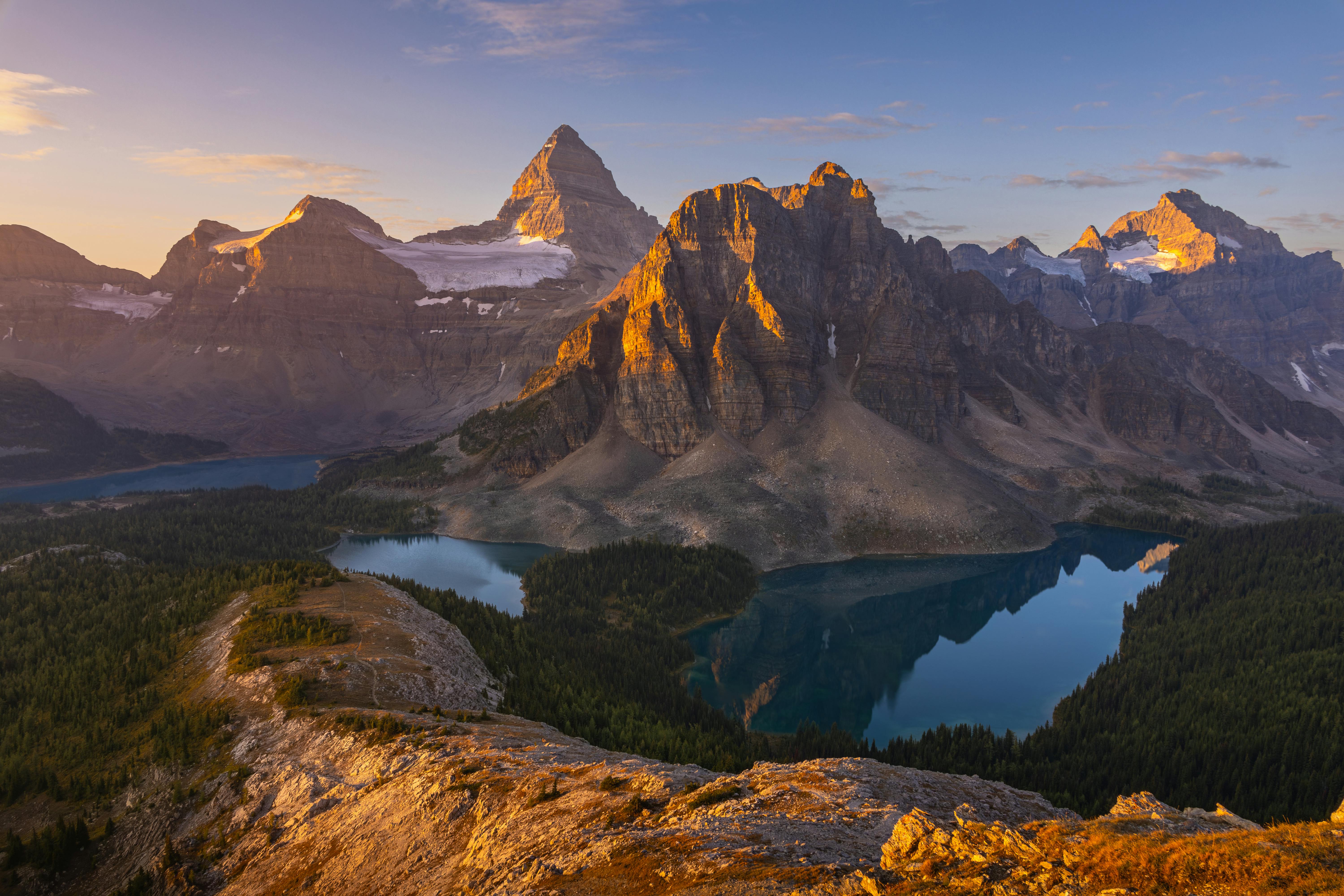 Stunning sunrise view of Mount Assiniboine reflecting in a glacial lake, Canada.