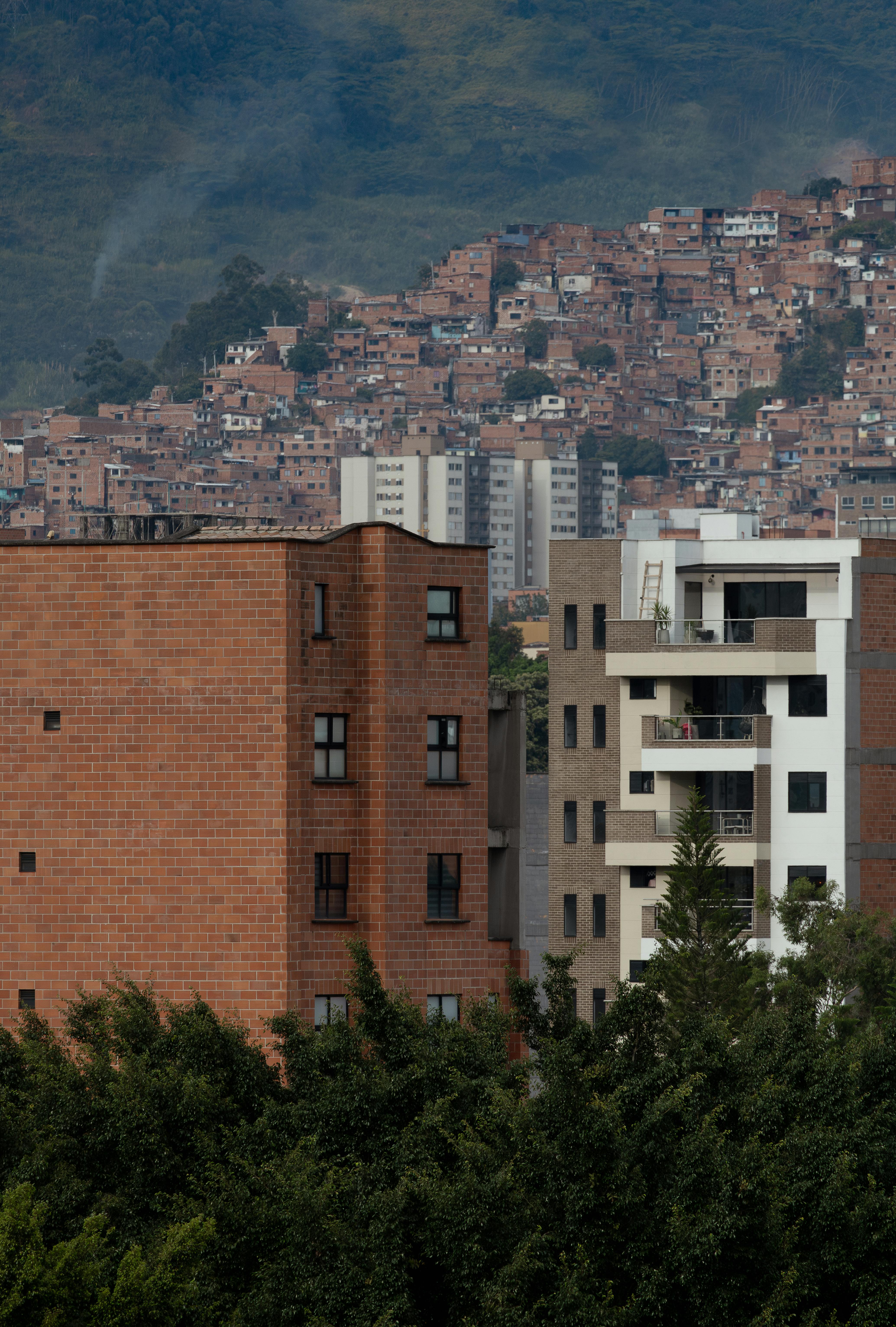 Explore the contrasting architecture of Medellín, Colombia, with urban buildings set against green landscapes.