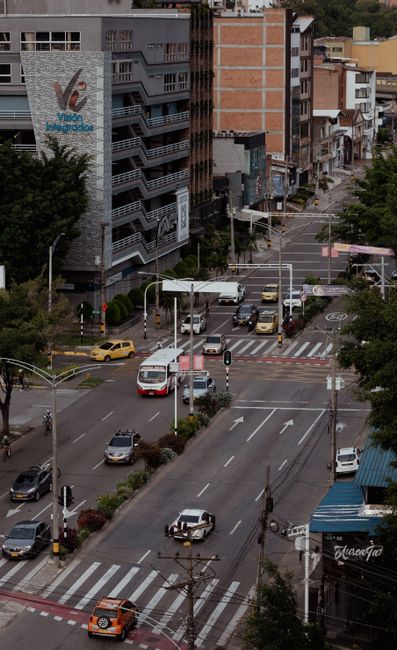 Dynamic Medellín street scene from above, capturing urban life and traffic.