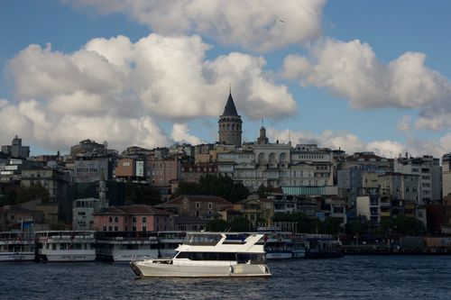 Free A picturesque view of the Galata Tower with waterfront and a boat in Istanbul. Stock Photo