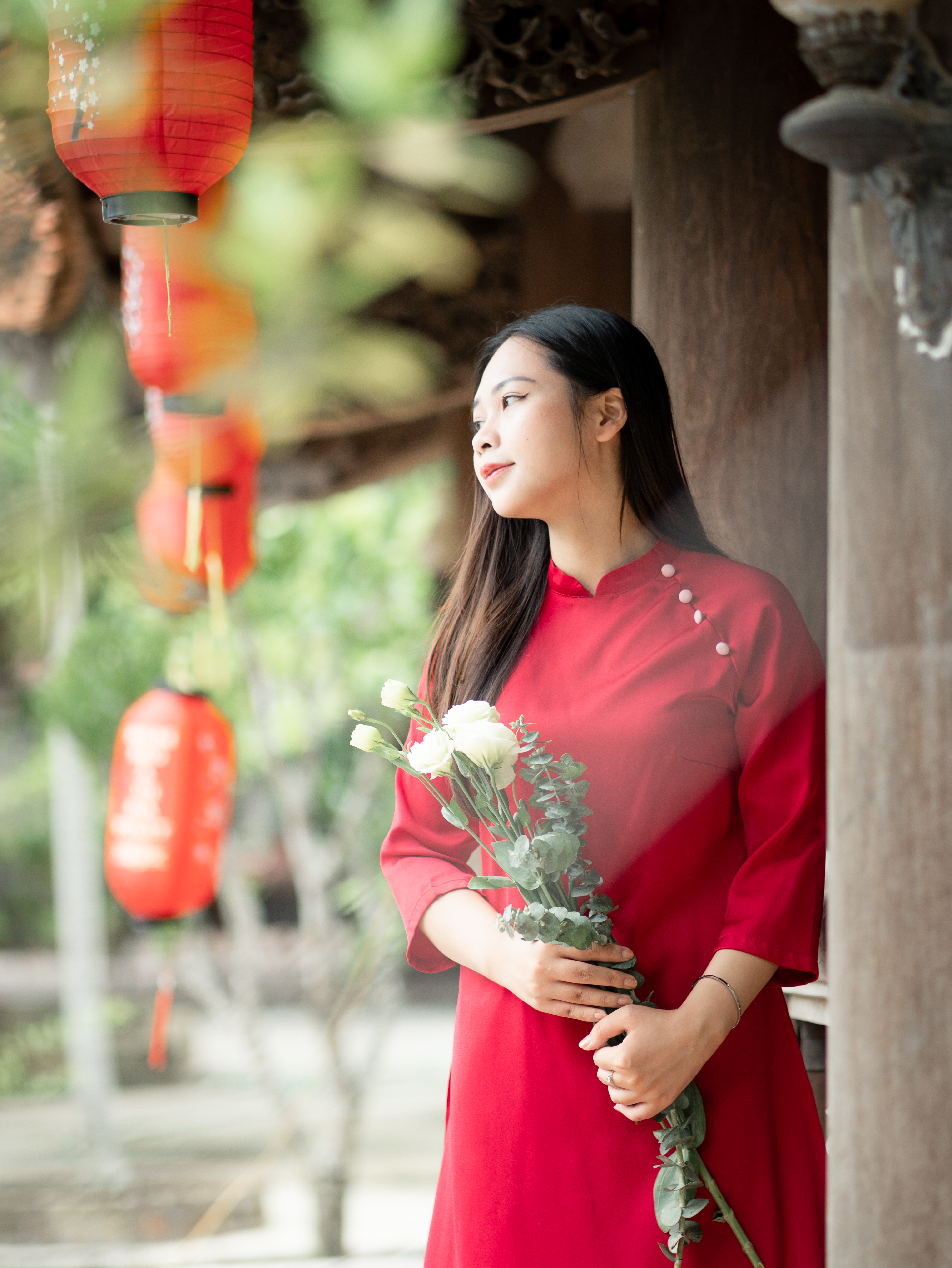 Woman in Red Dress Holding Flowers Outdoors · Free Stock Photo