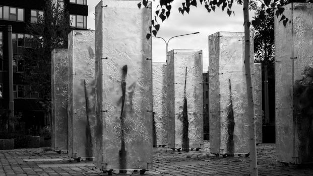 Black and white photo of modern city sculptures in an urban setting.