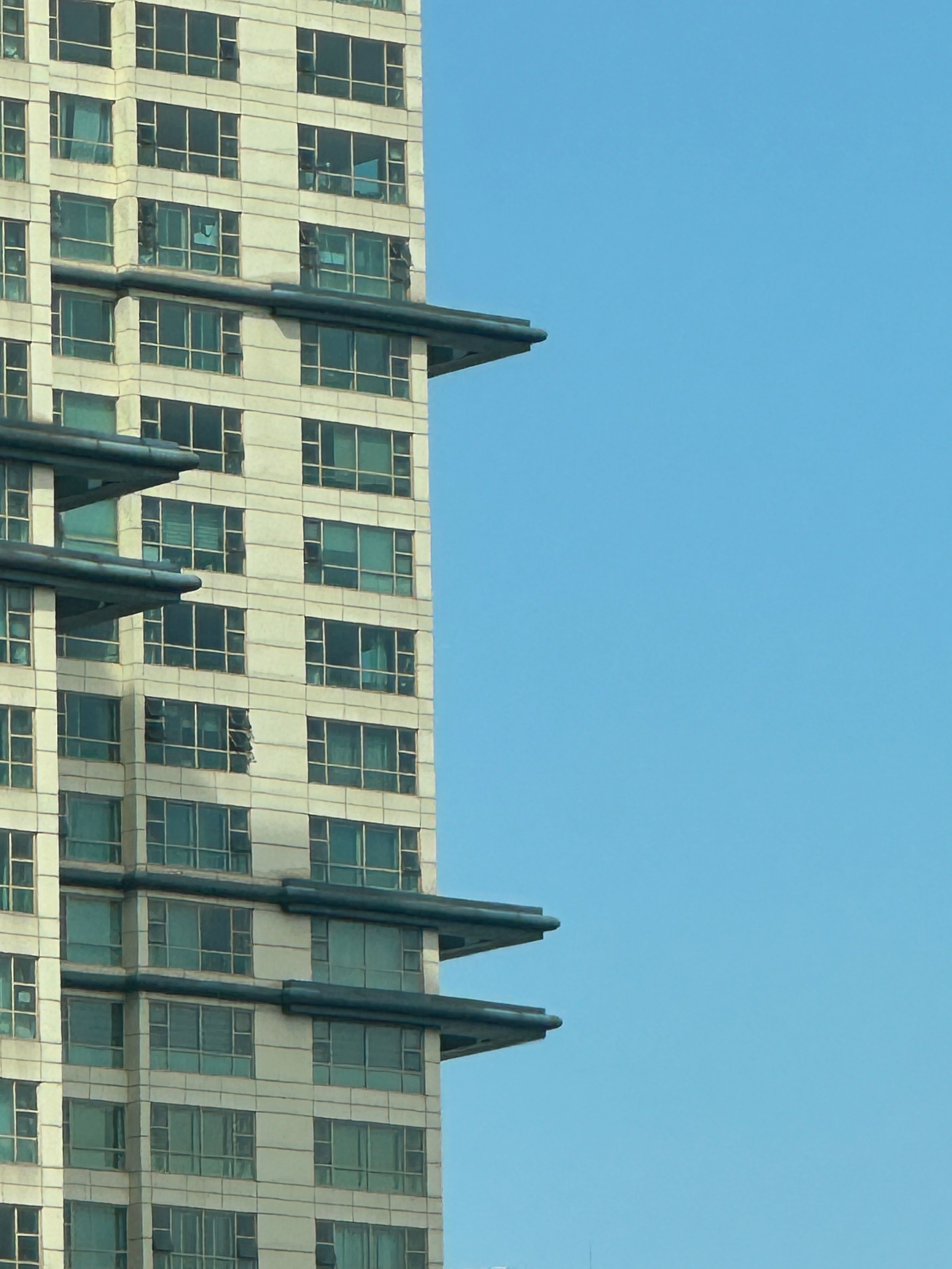 Modern High-Rise Building Against Blue Sky · Free Stock Photo
