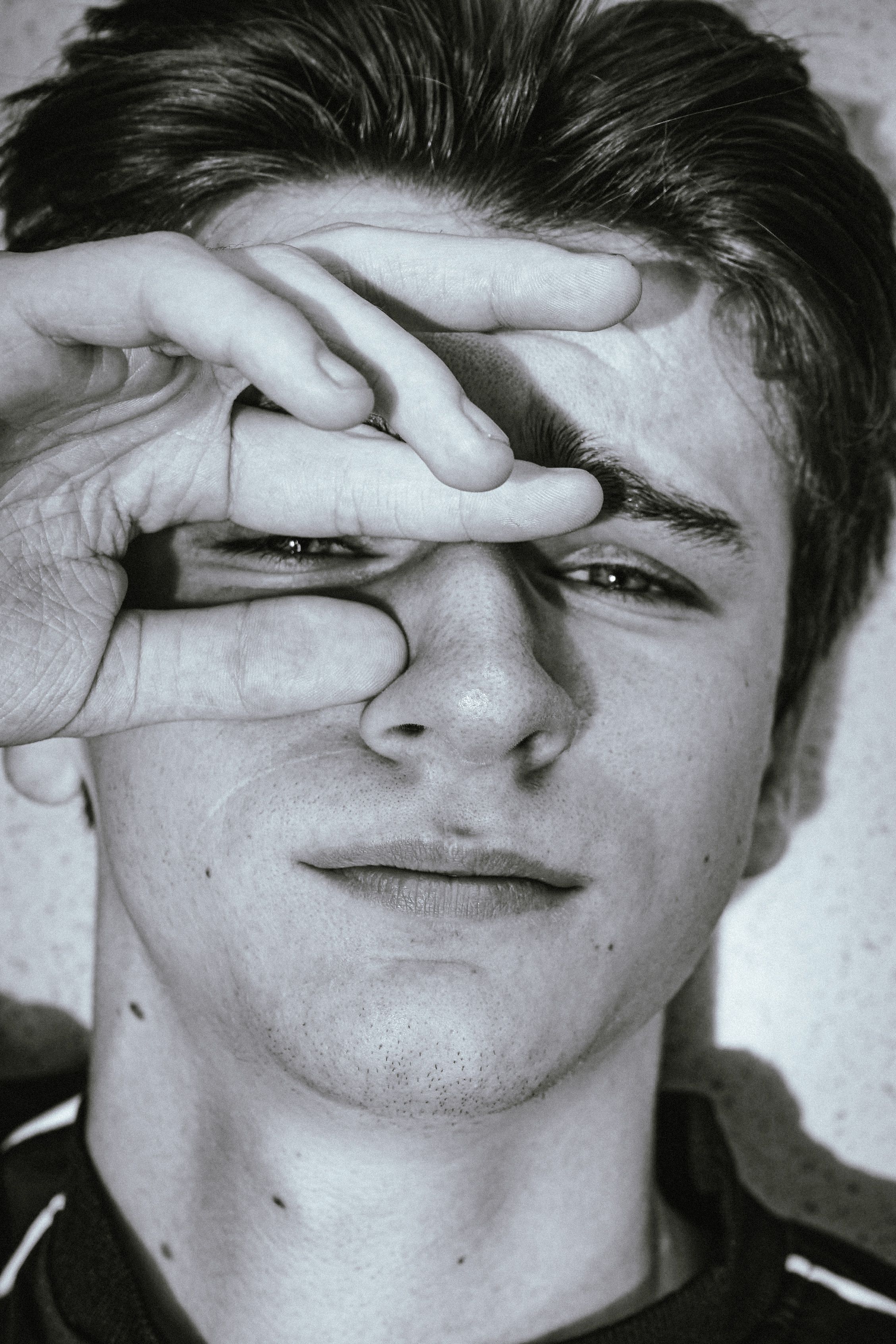 Black and White Portrait of Young Man with Hand Gesture · Free Stock Photo