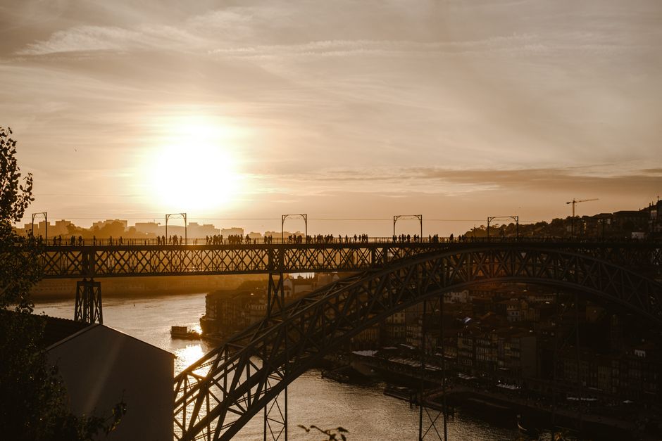 A stunning view of Porto's iconic <span class="notranslate"><em>Ponte</em></span> at sunset over the Douro River.