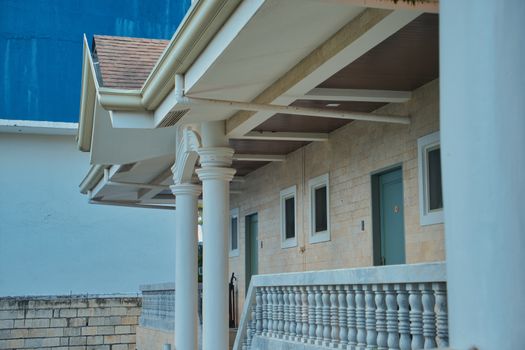 Stylish exterior design of a modern building featuring classic columns and stonework.