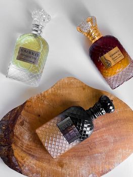 Artistic display of luxury perfume bottles on wooden surface for elegant branding.