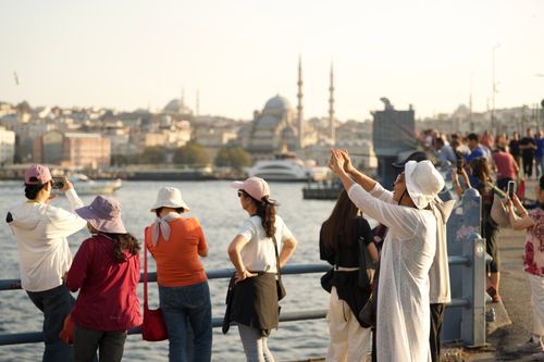 Free Tourists capturing the scenic view of Istanbul with historic landmarks under the sunny sky. Stock Photo