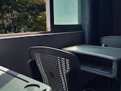 Sunlit Classroom with Empty Desks and Chairs
