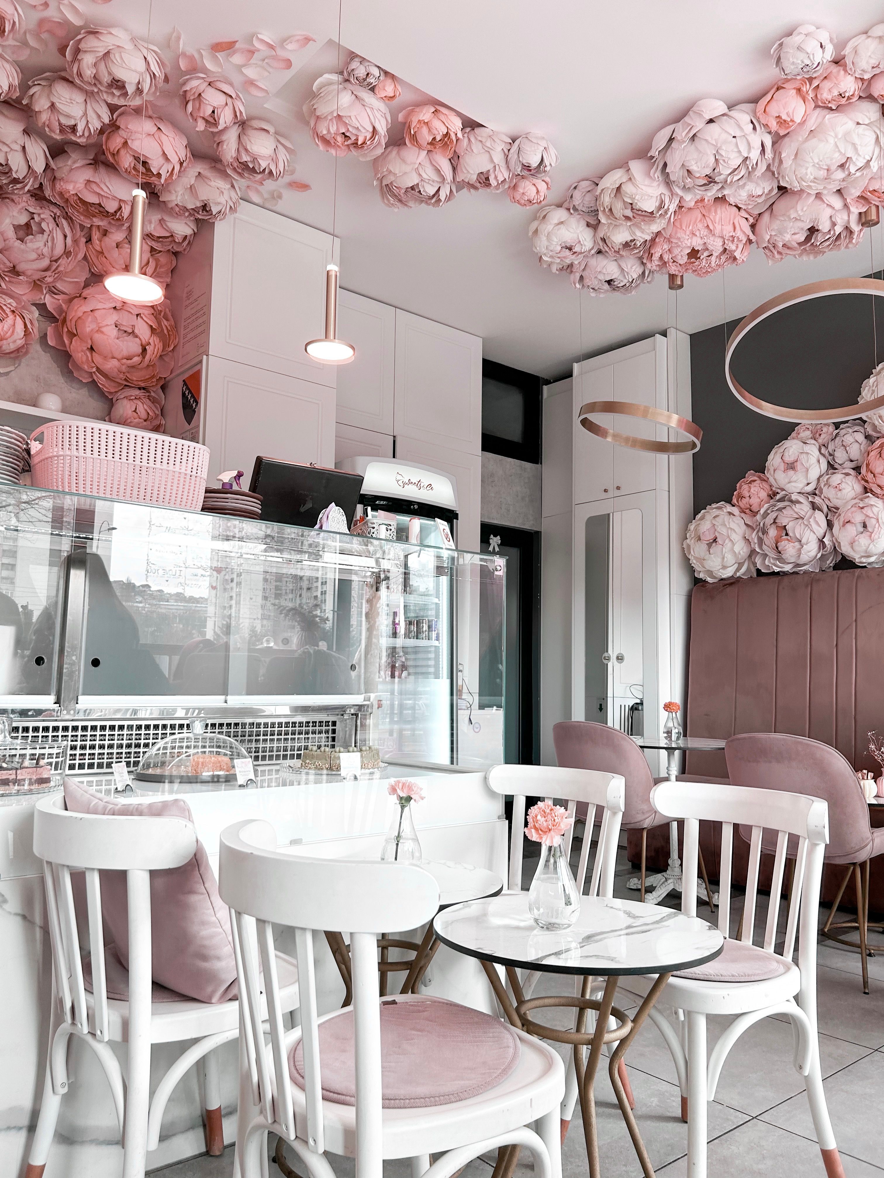 Charming Cafe with Pink Floral Decor and Cozy Ambiance · Free Stock Photo