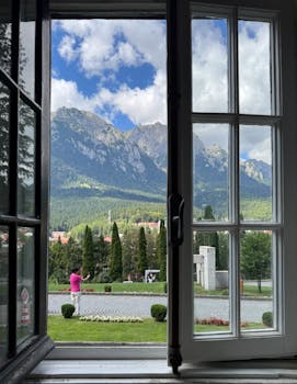 Captivating view of the Bucegi Mountains framed by a window, offering a glimpse of nature in Bușteni.
