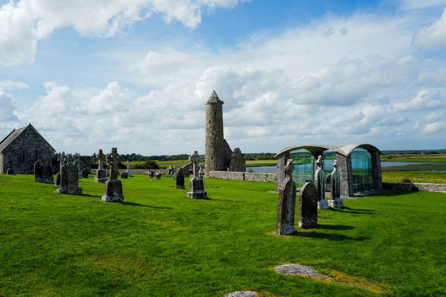 Beauty of an ancient Irish cemetery with a distinctive round tower set against a green landscape