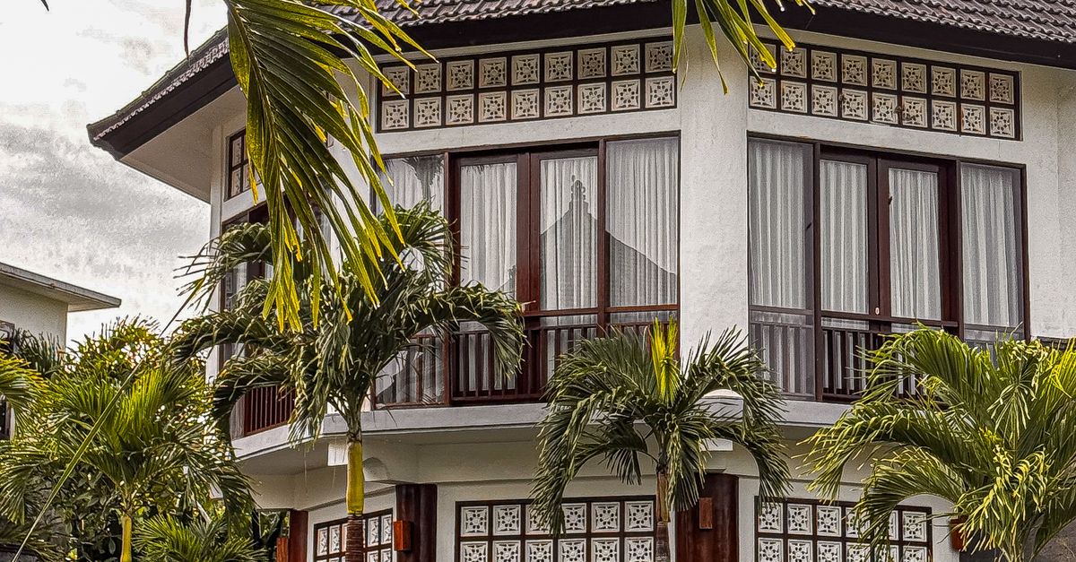 Elegant Balinese villa with tropical garden and pool, perfect for a luxury retreat.