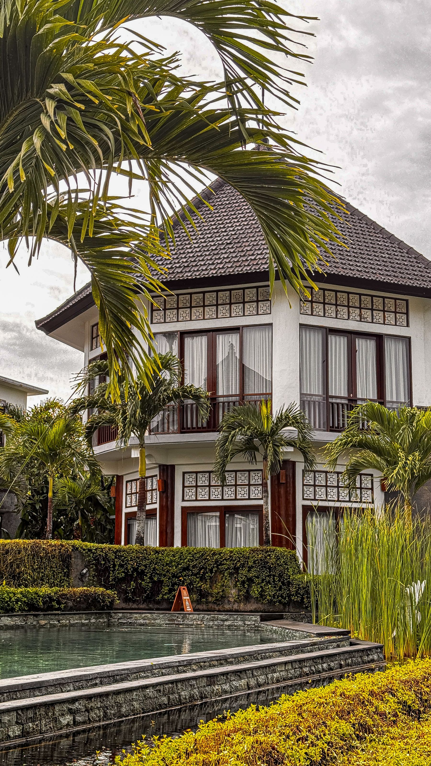 Empty two-story Balinese-style villa, tropical garden, and private pool