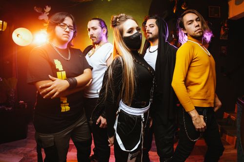 Free A vibrant photo of a music band posing indoors with dramatic lighting and stylish outfits. Stock Photo