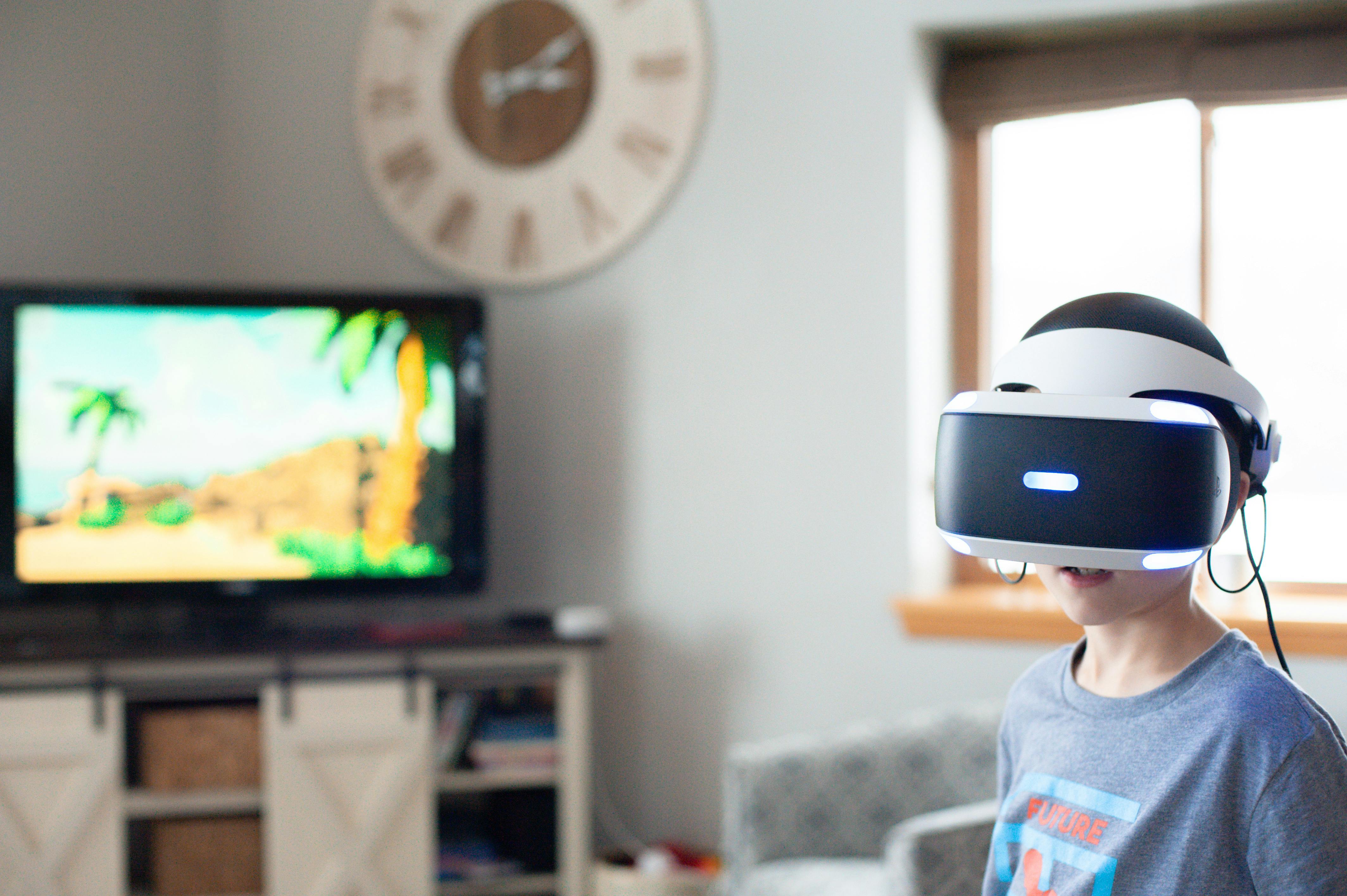 boy wearing black and white virtual reality headset